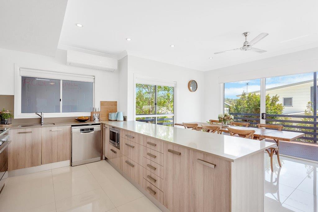 Sunlit, clean kitchen and dining space